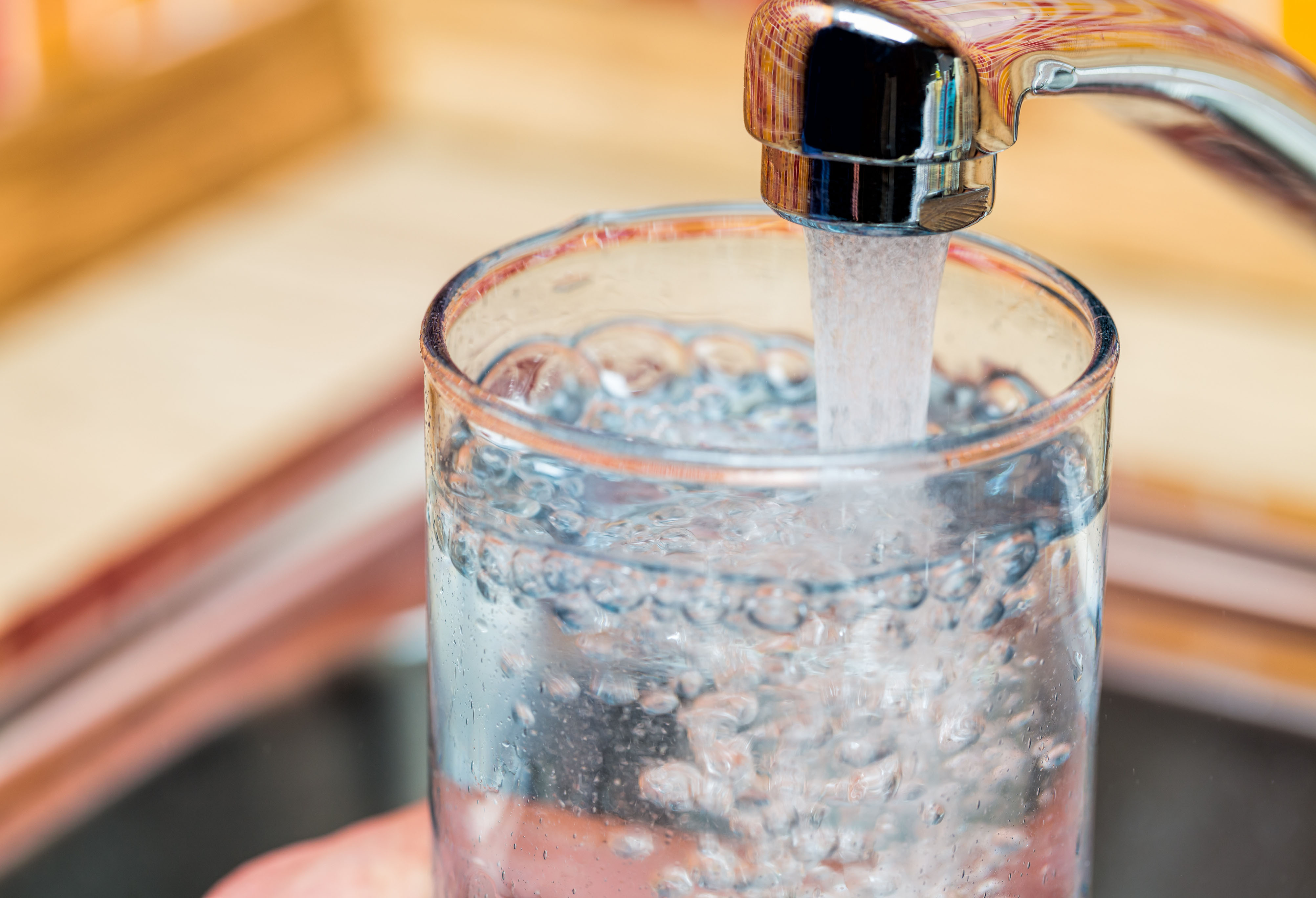 Filling up a glass with drinking water from kitchen tap_rdx.jpg